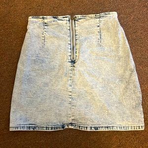 This skirt is a size medium for women with zipper. The color is a light blue.